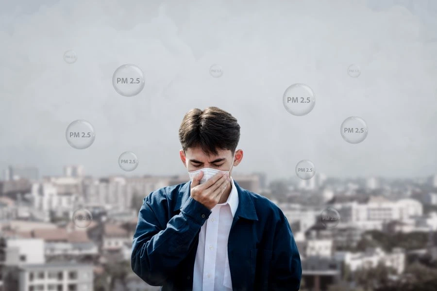 man wearing facemask coughs with pollution quality of dust PM 2.5